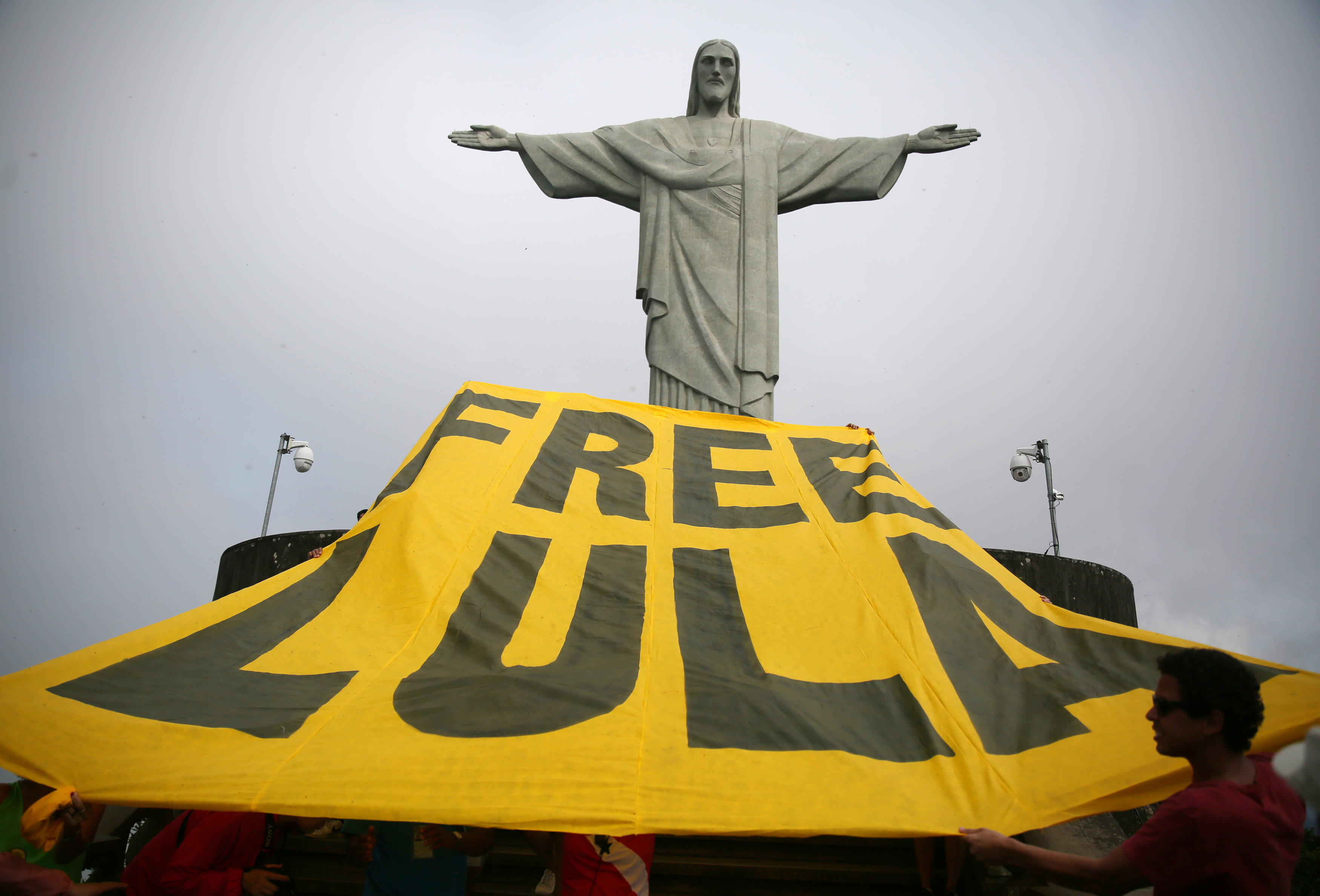 Supporters of former Brazilian President Luiz Inacio Lula da Silva display a banner in front of the statue of Christ the Redeemer in Rio de Janeiro, Brazil, on April 14, 2018. Supporters of former Brazilian President Luiz Inacio Lula da Silva display a yellow banner reading "Free Lula" in front of the statue of Christ the Redeemer in Rio de Janeiro, Brazil, on April 14, 2018.